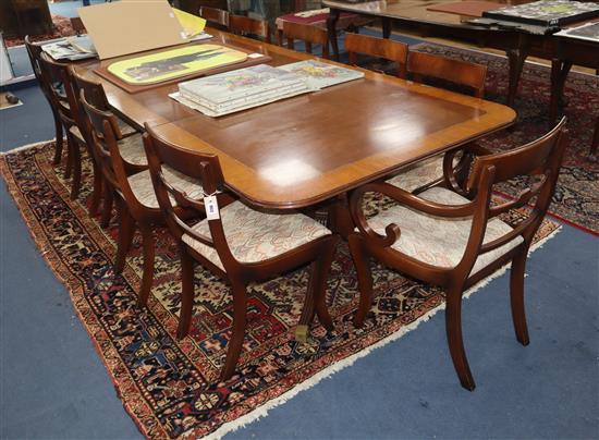 A Regency style satinwood banded mahogany twin pillar extending dining table together with a set of twelve Table 305cm extended (two sp